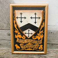 Wooden plaque with a shield design and decorative elements on a wooden surface