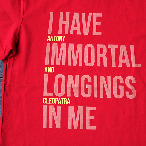 
                      
                        Red graphic t-shirt with pale orange and bright yellow graphic text aligned to the left
                      
                    