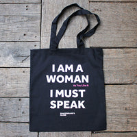 a black bag with white text on a wooden  surface
