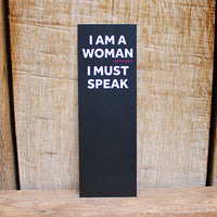 black card bookmark with white text on a wooden background