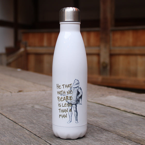 white metal water bottle with a silver lid and a black and green print, sitting on wooden stage