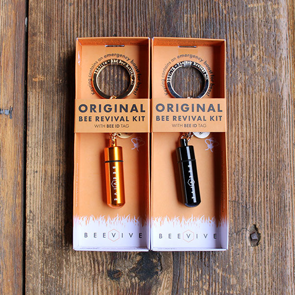 keyrings with a metal capsule attached in orange packaging