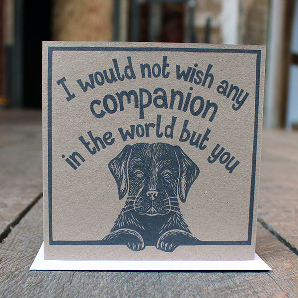 Brown kraft card with black linocut quote and black labrador image