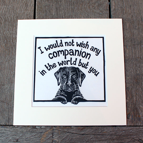 Off white mounted print with black linocut design of black labrador and stylised quote text above