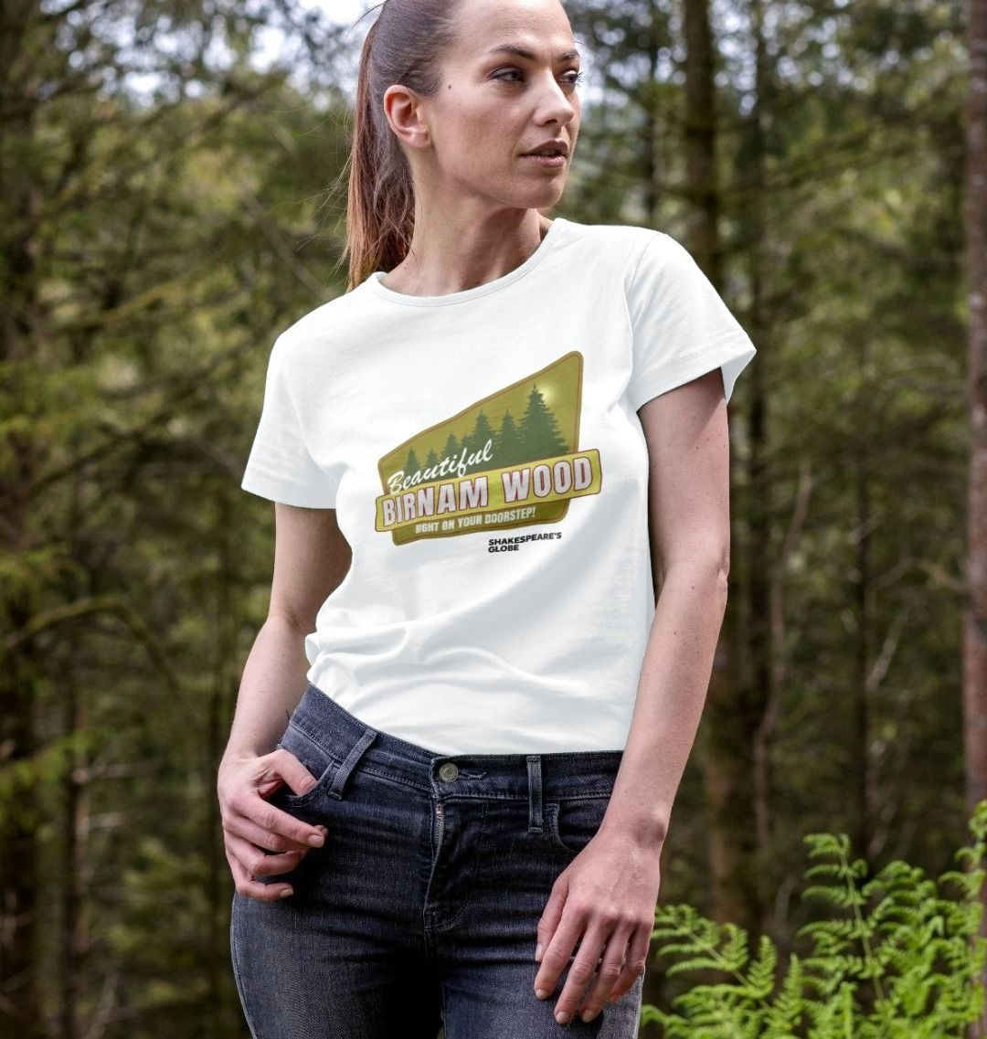 White fitted t-shirt with yellow and green vintage travel poster image of forest, with white graphic text over top