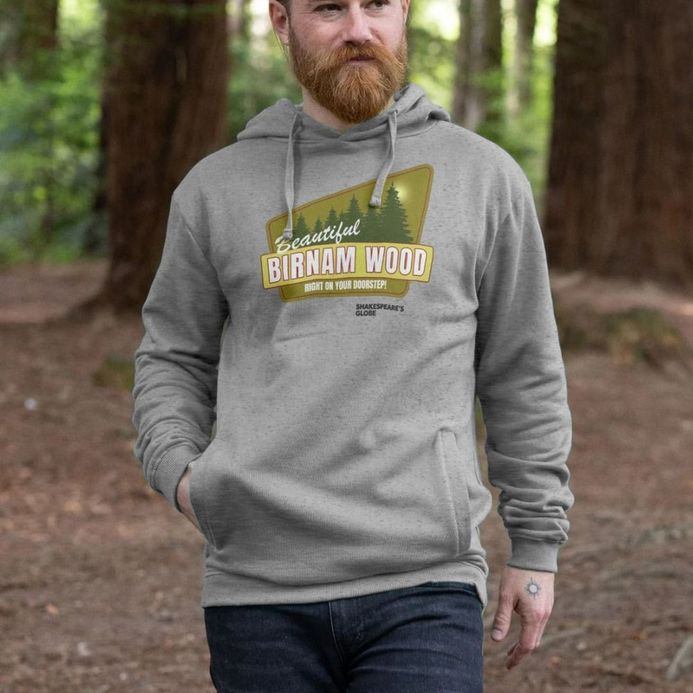 Grey hoodie with yellow and green vintage travel poster image of forest, with white graphic text over top