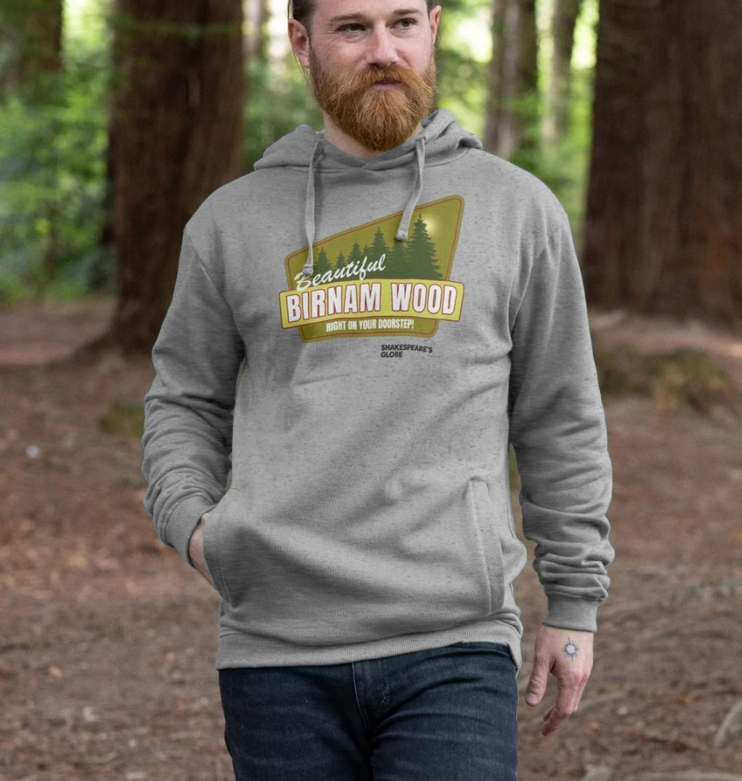 Grey hoodie with yellow and green vintage travel poster image of forest, with white graphic text over top