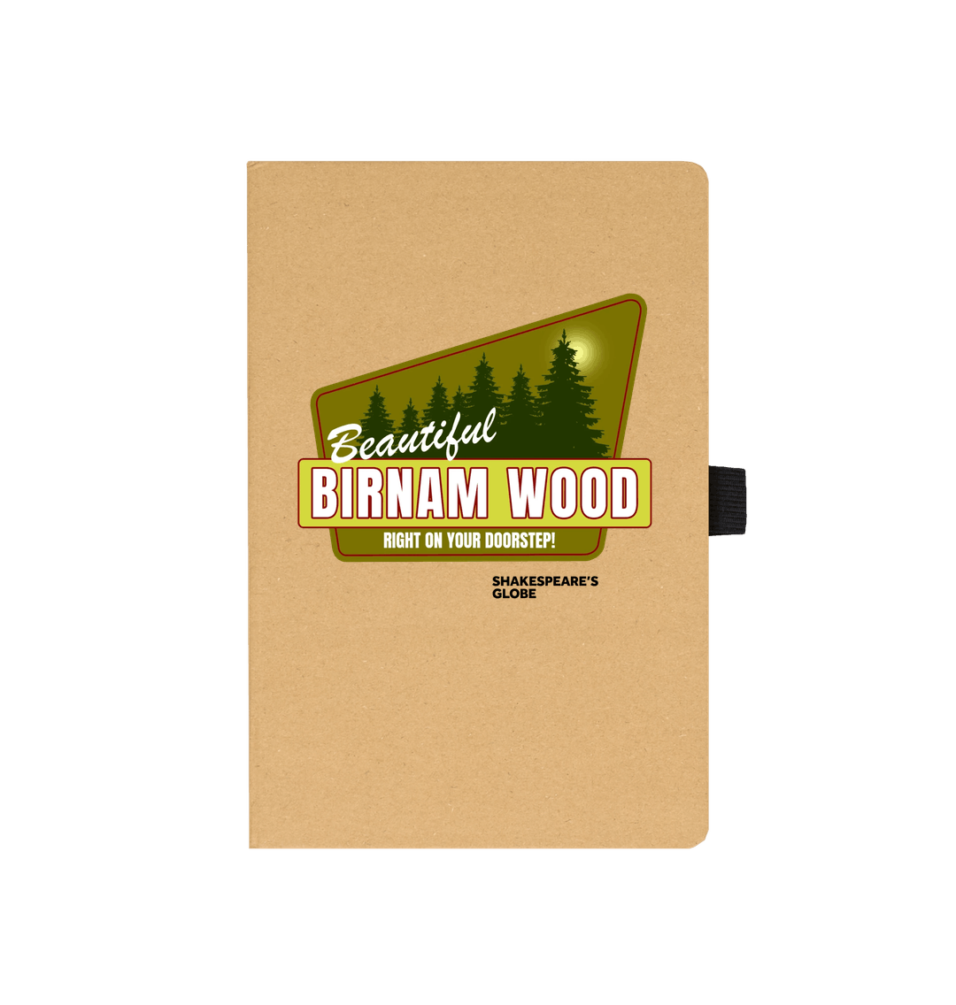 Kraft notebook with yellow and green vintage travel poster image of forest, with white graphic text over top