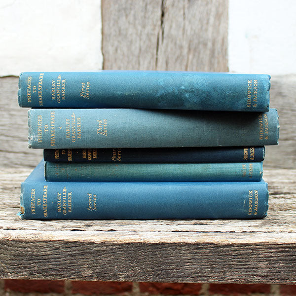 Stack of blue books on a wooden surface
