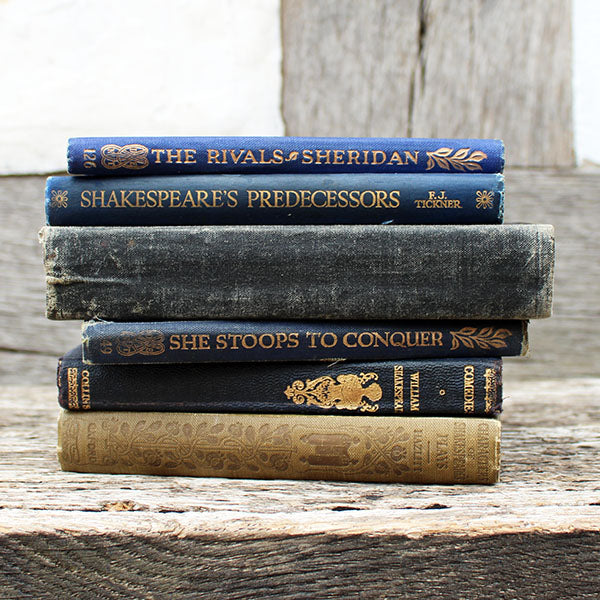 Stack of vintage books on a wooden surface