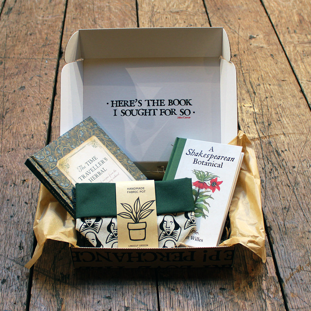 
                      
                        Kraft book box, open with white interior, filled with 2 green hardback books and 1 green, black and beige fabric plant pot
                      
                    