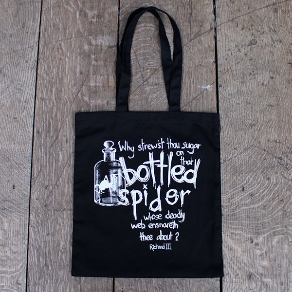Black cotton 2 handle bag with white graphic text and imagery on front