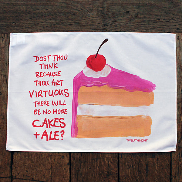 White cotton landscape orientated tea towel with large oil painting of cake slice with red scratchy writing down the left side