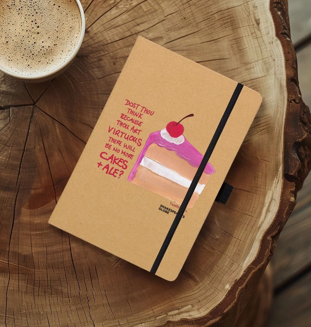 Kraft notebook with image of painted piece of vanilla cake with pink icing and red scratchy text on top, with black elastic closure