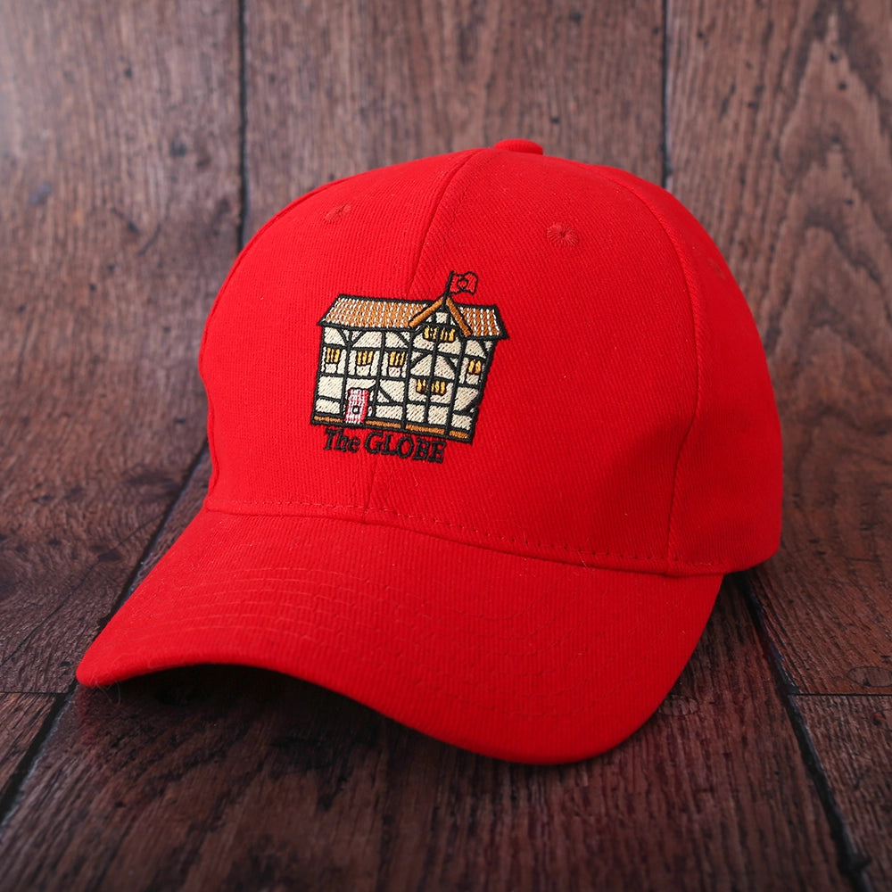 Red cotton baseball cap with curved bill and embroidered cartoon Shakespeare's Globe on front