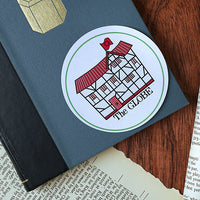 Sticker with a red building design and 'The Globe' text on a blue notebook