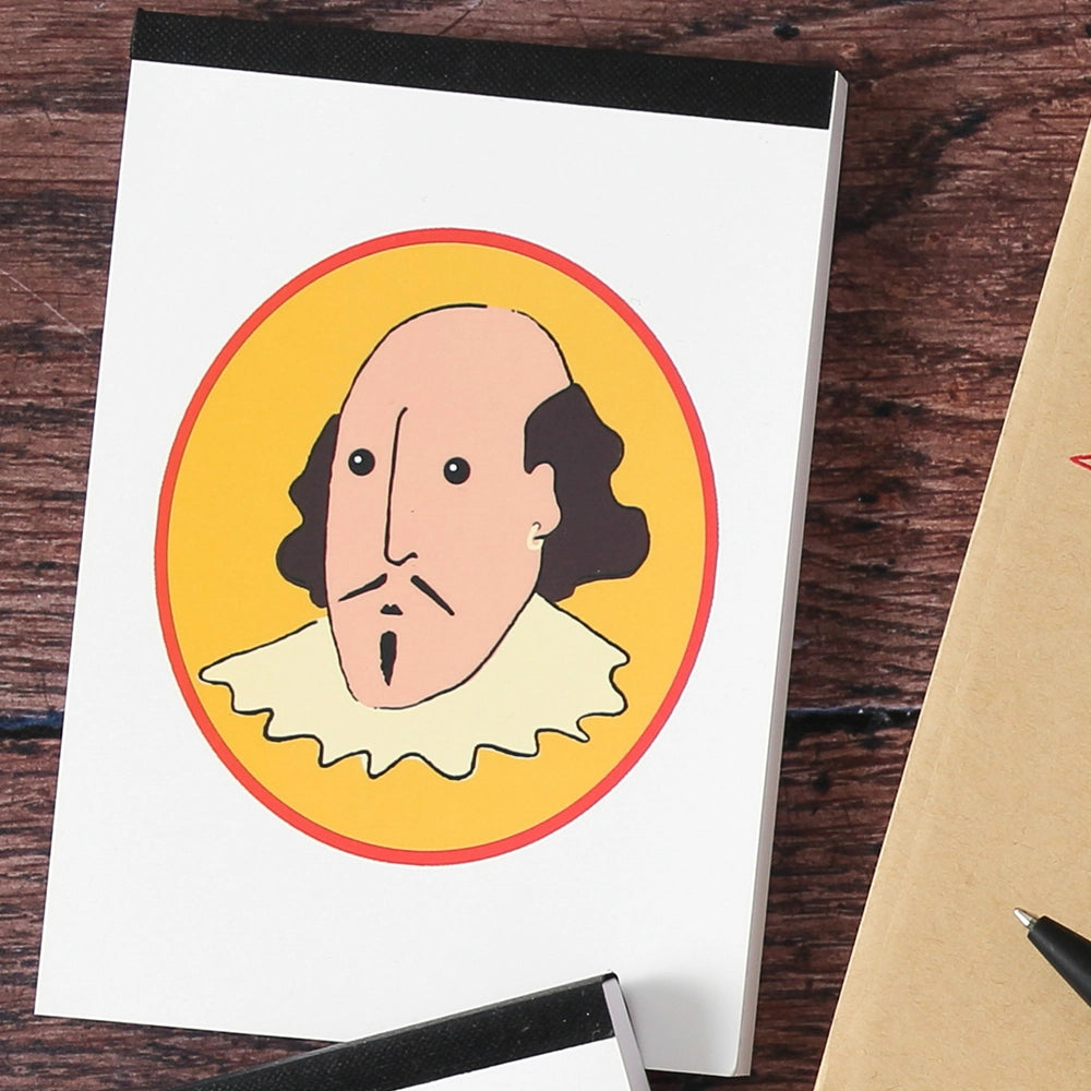 White paperback notepad with oval yellow graphic on centre front of cartoon William Shakespeare