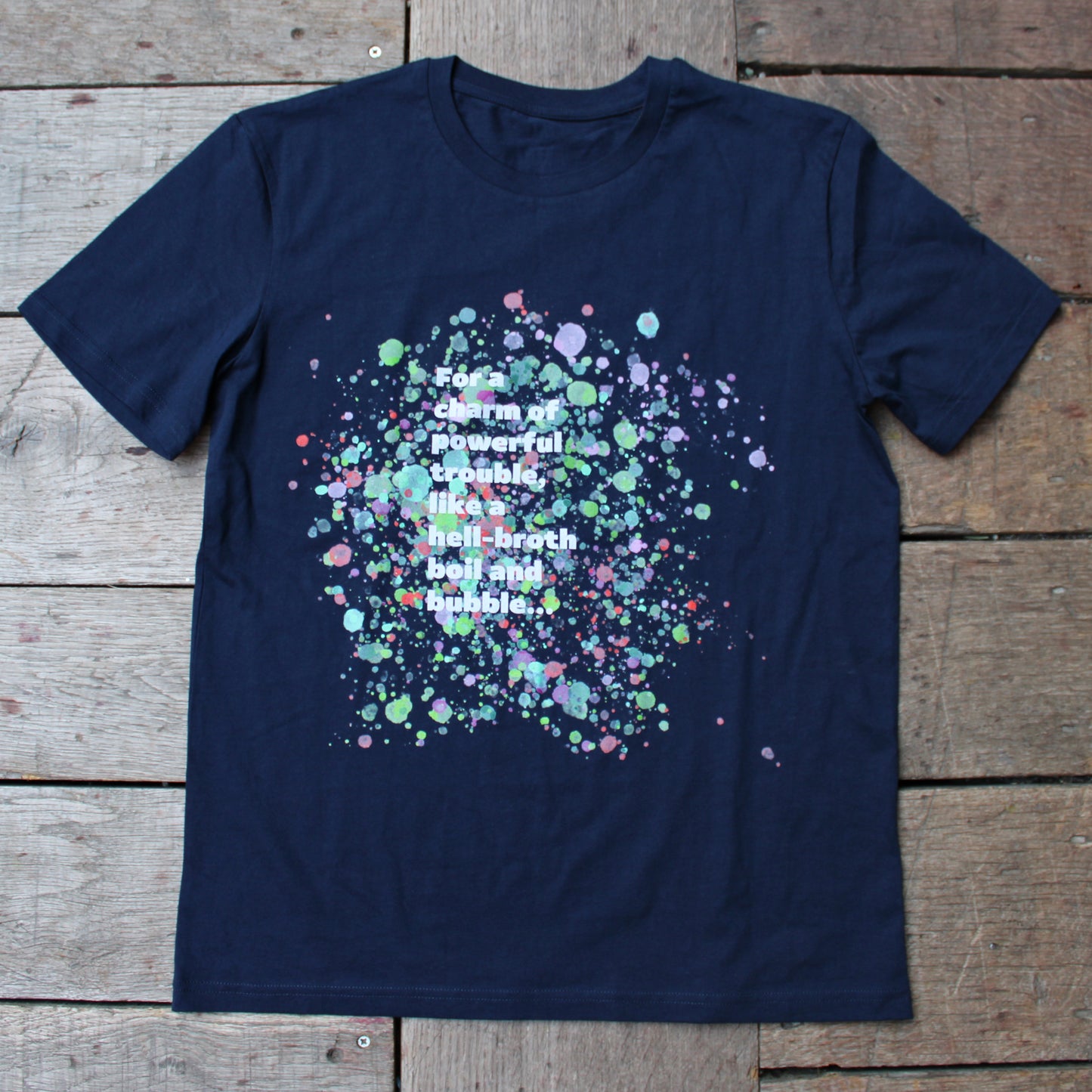 Navy blue t-shirt with pale blue, green, pink and purple bubbles behind white graphic text