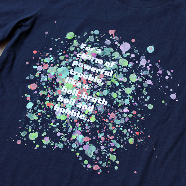 
                  
                    Navy blue t-shirt with pale blue, green, pink and purple bubbles behind white graphic text
                  
                