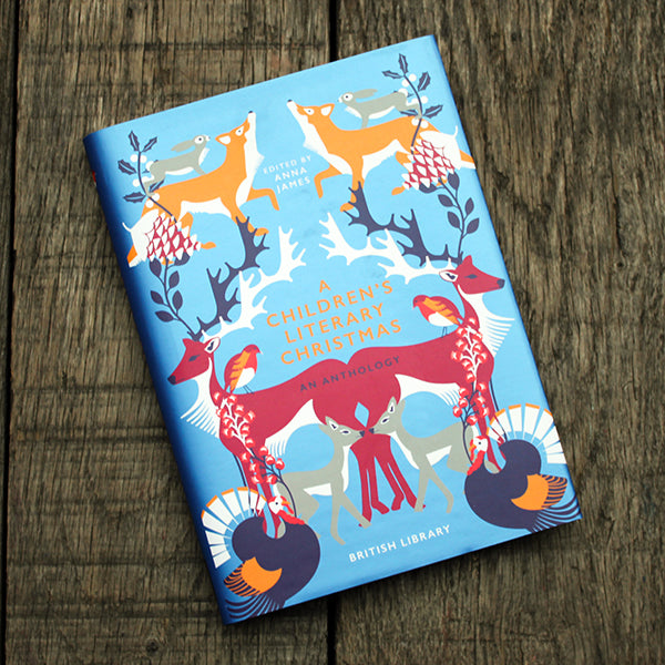 Children's literary Christmas book with animal illustrations on a wooden surface