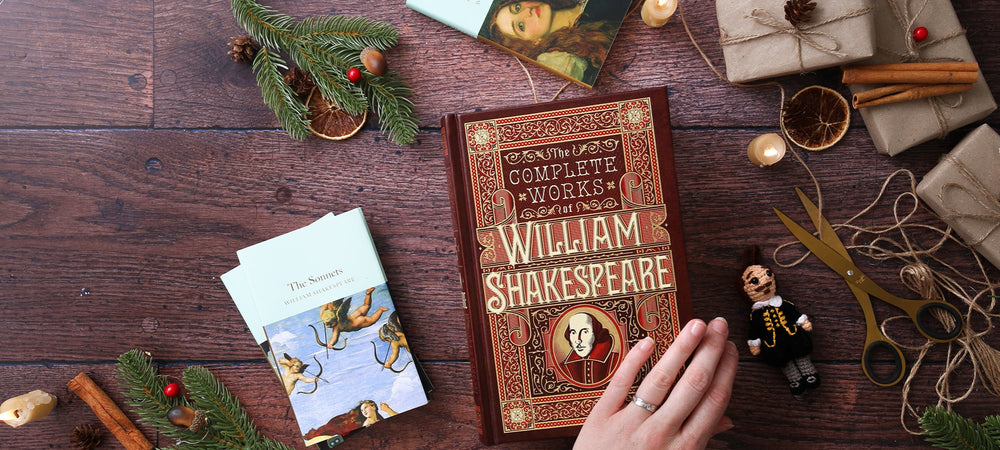 Hardback Shakespeare play texts lying on wood plank floor, with scissors, string, and wrapped brown packages