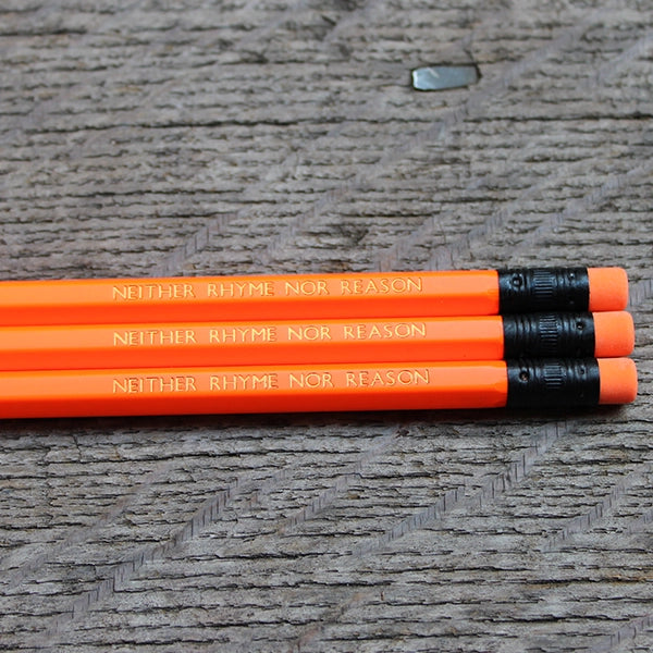 Neon orange pencil with matching eraser and gold etched text