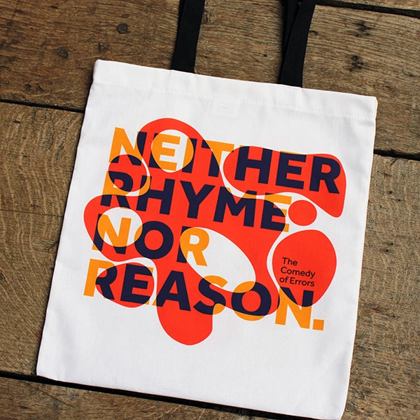 
                      
                        White cotton tote bag with 2 black handles, with orange bubbly graphic and purple and yellow text
                      
                    