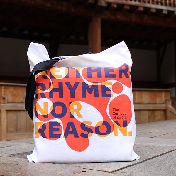 
                      
                        White cotton tote bag with 2 black handles, with orange bubbly graphic and purple and yellow text
                      
                    