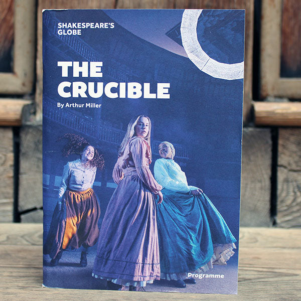 Indigo coloured paperback programme with white text and graphics and 3 women on the front cover in traditional dress