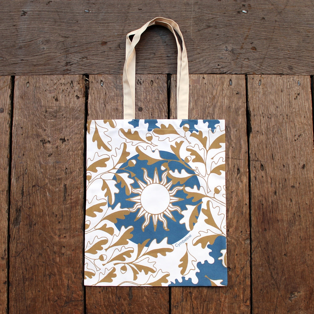 
                      
                        Blue printed cotton tote bag with gold and natural leaf and sun motif
                      
                    