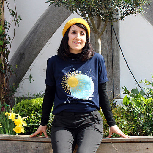 Navy blue t-shirt with pale blue moon and yellow sun graphic with white text