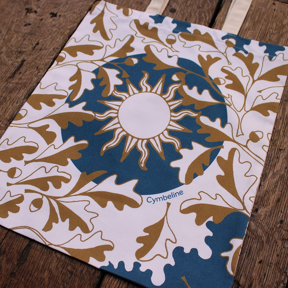 
                      
                        Blue printed cotton tote bag with gold and natural leaf and sun motif
                      
                    