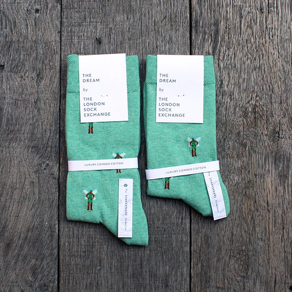 
                  
                    Teal cotton blend sock with repeating pattern of fairy from A Midsummer Night's dream, spaced an inch apart from one another, sock is shown in white card packaging
                  
                
