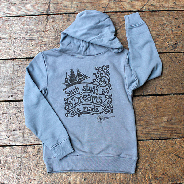 Light blue hoodie with graphic design on a wooden surface