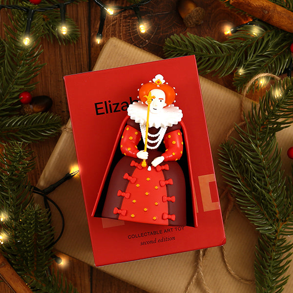 Collectible art toy in a red box with 'Elizabeth' branding, surrounded by Christmas decorations.