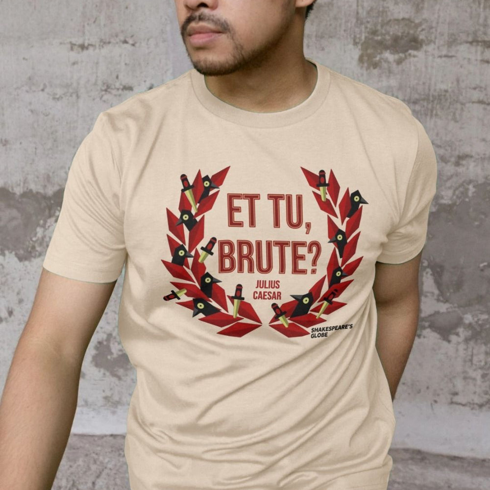 Beige t-shirt with centre front graphic of red laurel wreath with ravens and daggers within it, surrounding red graphic text