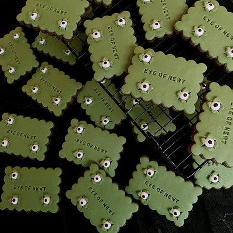 
                      
                        Green rectangular biscuits with white eyes popping out of the printed fondant
                      
                    