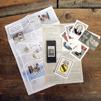 A collection of maps and papers on a wooden surface