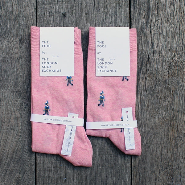 
                      
                        Pale pink cotton blend socks with fool character repeat pattern approximately 1 inch between each character, packaged in white card
                      
                    