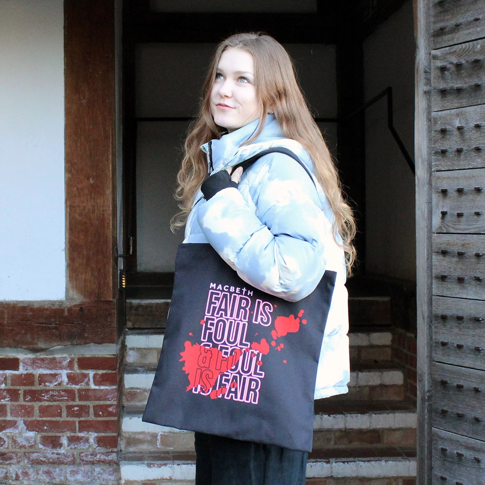 Black cotton two handle tote bag with graphic pink text and red blood smear imagery