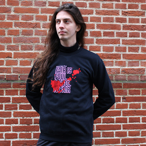 Black polycotton sweatshirt with hot pink central quote text and blood smear image on male model with long wavy brown hair