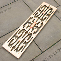 Decorative wooden grate on a stone pavement