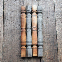 Set of wooden balusters in two colors on a wooden surface
