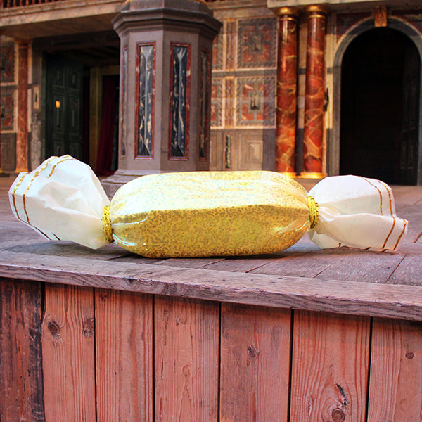 gold sequined sweet prop on a wooden stage
