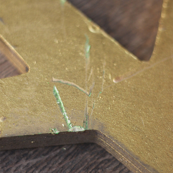 
                  
                    Plywood tree segment, painted gold, with jagged tree branches, from Much Ado About Nothing summer 2024 on the Globe Stage.
                  
                