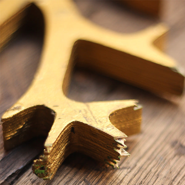 
                  
                    Plywood tree segment, painted gold, with jagged tree branches, from Much Ado About Nothing summer 2024 on the Globe Stage.
                  
                