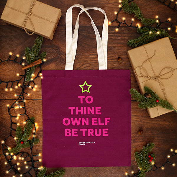 Purple tote bag with humorous text on a wooden surface with Christmas decorations