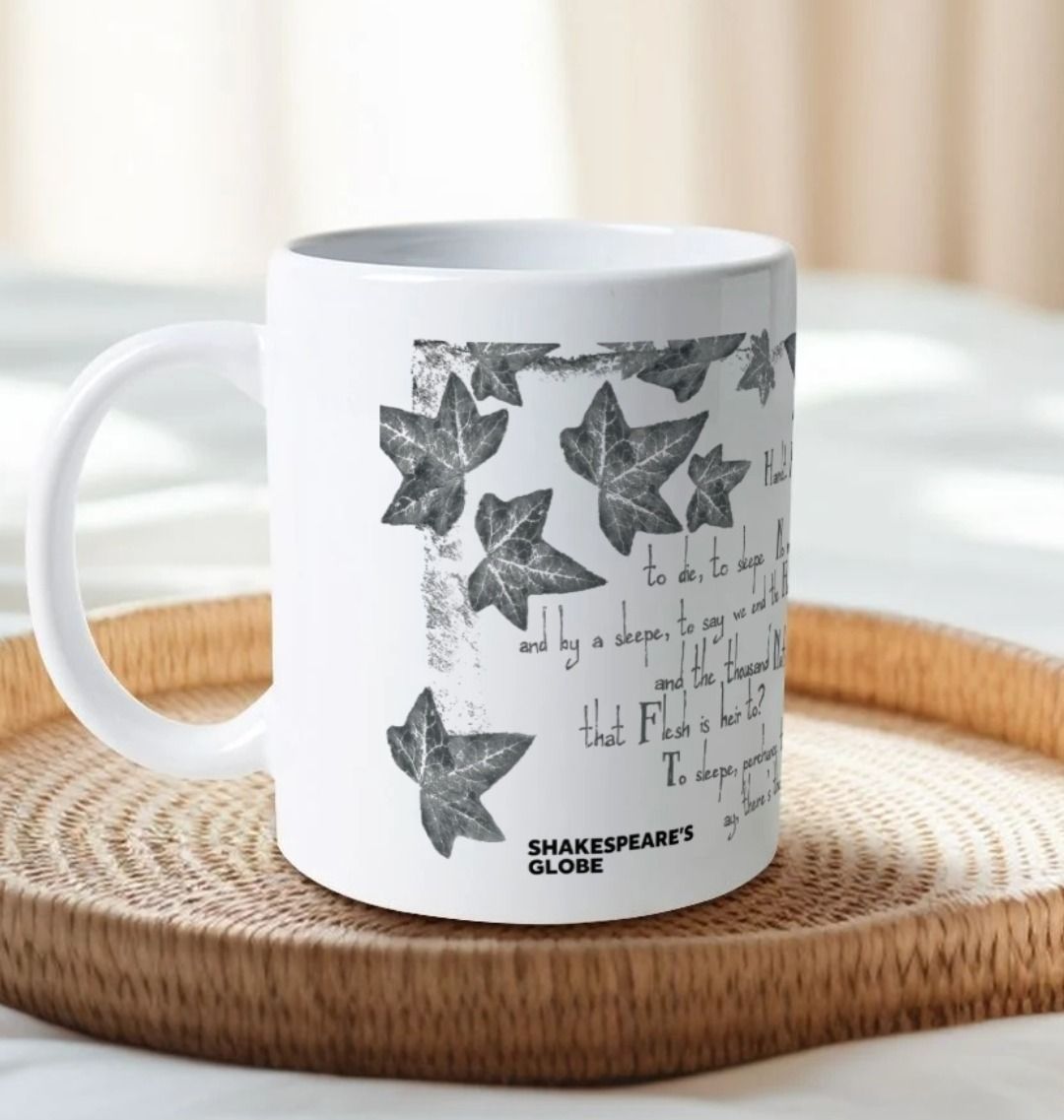 White mug with grey leafy graphics with scratchy 'to be' quotes text on either side