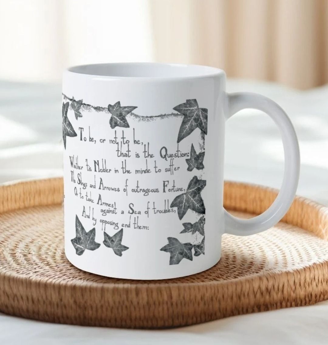 White mug with grey leafy graphics with scratchy 'to be' quotes text on either side