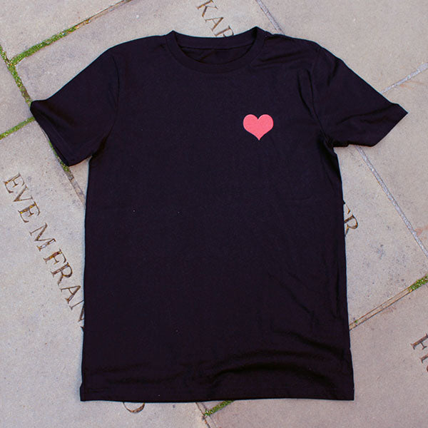 black t-shirt printed on the from with a small red heart
